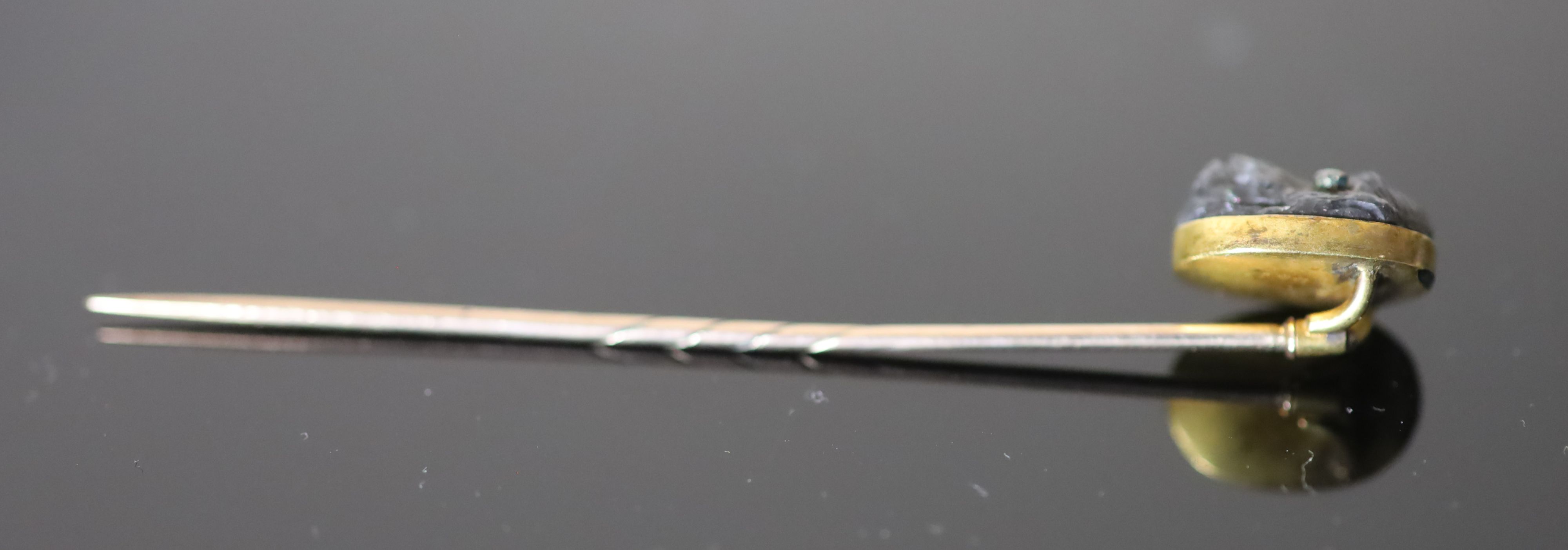 A Victorian gold mounted diamond set labradorite? stick pin, carved as the head of an ape,